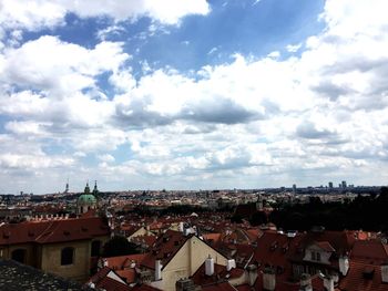 Cityscape against cloudy sky