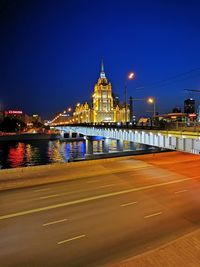 Light trails on bridge over river at night