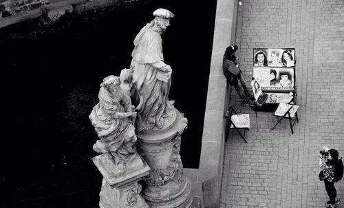 Statue against wall and building
