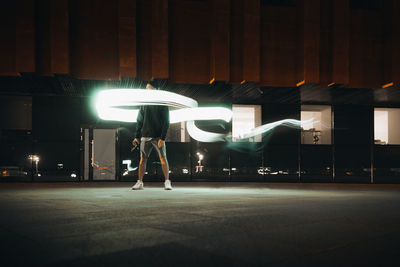 Man standing on illuminated stage