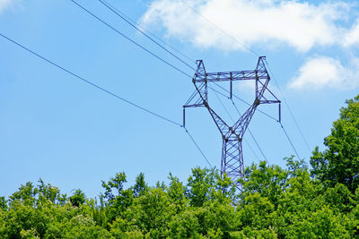 Low angle view of electricity pylon against sky