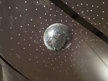 Low angle view of disco ball hanging on ceiling
