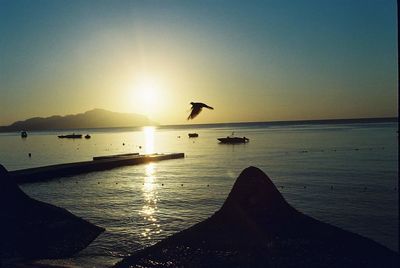 Scenic view of sea against clear sky during sunset