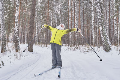 Full length of man skiing on snow covered landscape