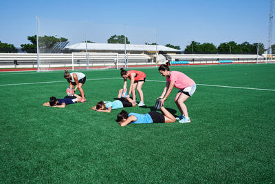 Group of people playing soccer on field