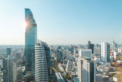 Modern buildings in city against clear sky