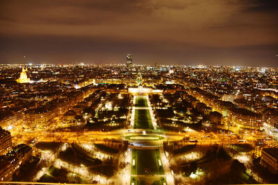 High angle view of city lit up at night