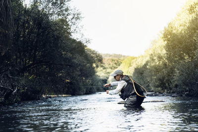 Man sitting on boat in river