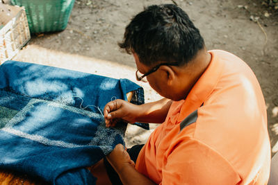 High angle view of man sitting outdoors