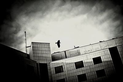 Low angle view of building against cloudy sky