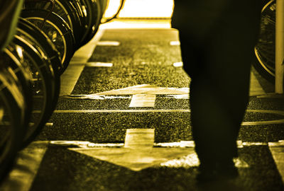 Low section of man walking on road