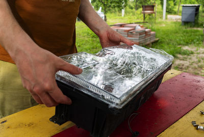 Midsection of man working on table