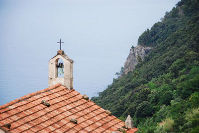 Little church, green mountain and the ligurian sea at setta in framura, la spezia, italy.