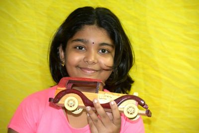 Portrait of a smiling girl holding yellow