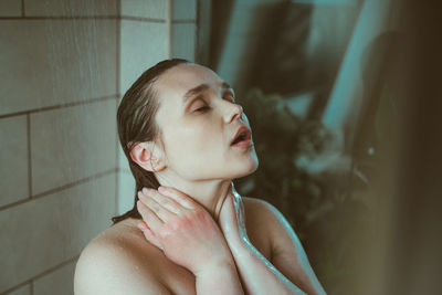 Portrait of young woman in bathroom