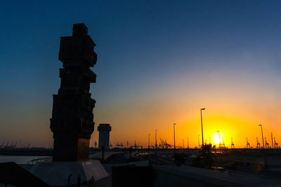 Silhouette building against sky during sunset