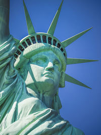 Statue of liberty against blue sky