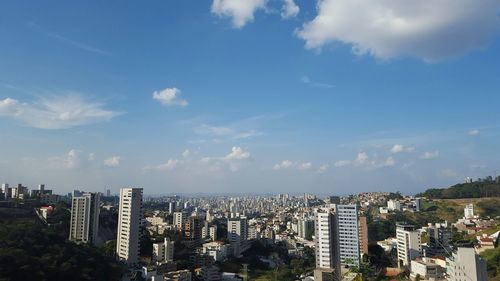 View of cityscape against cloudy sky