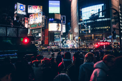 Crowd on city street at night