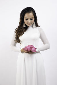 Young woman holding white flower