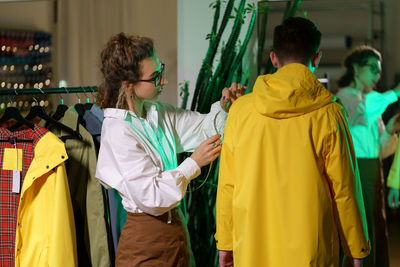 Making measures for tailoring. clothes designer workshop with girl tailor measuring bespoke jacket