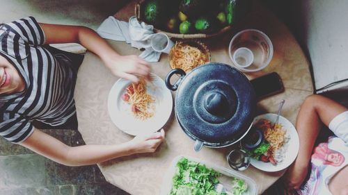 Directly above shot of women sitting at dining table