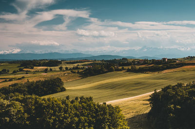 Scenic view of landscape against cloudy sky