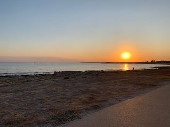 Scenic view of sea against clear sky during sunset