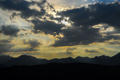 Scenic view of silhouette mountains against sky during sunset