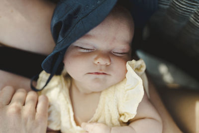 Close-up of baby sleeping on bed
