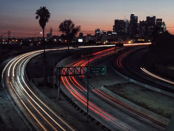 High angle view of light trails on highway at dusk