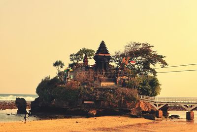 Traditional building against sky during sunset