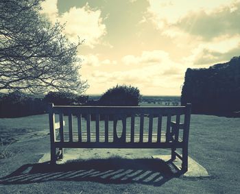 Empty bench at sunset
