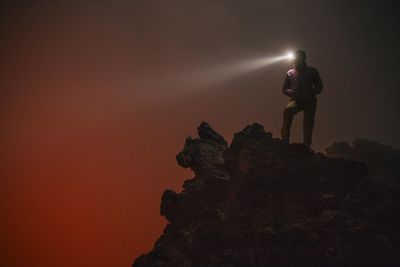 Silhouette of man against sky at night