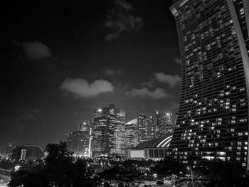 Illuminated cityscape against sky at night