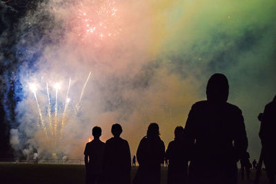 Low angle view of silhouette people against sky at night