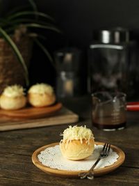 Close-up of cheese bun in plate on table