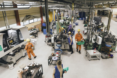 Female and male workers wearing uniform working in factory warehouse