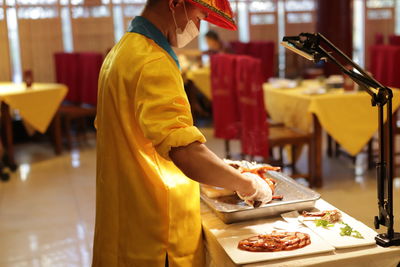 Side view of man preparing food at restaurant