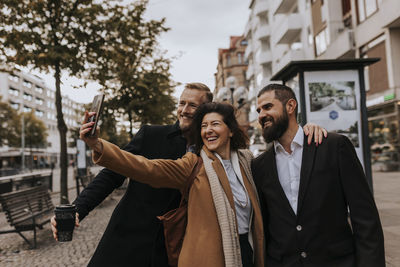 Smiling business people taking selfie