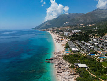 High angle view of townscape by sea against sky