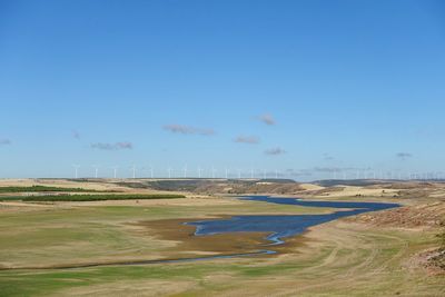 Scenic view of landscape against blue sky