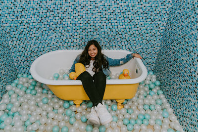 Girl sitting in a bathtub