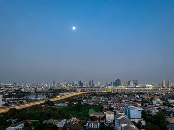 Illuminated cityscape against sky at night