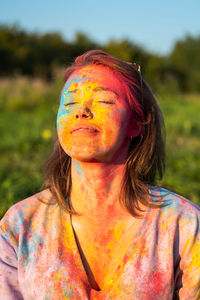 Woman covered holi powder in park. holi colours festival.