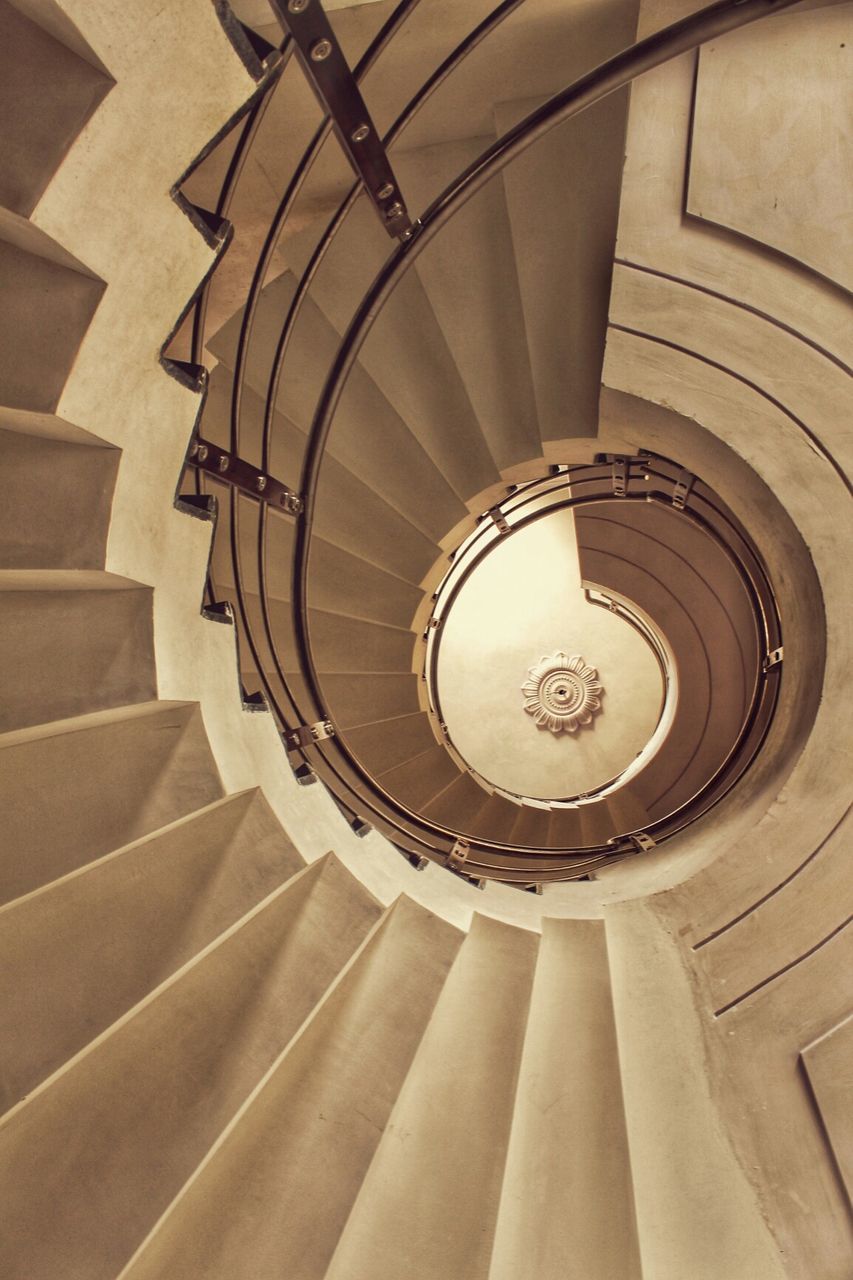 indoors, steps and staircases, staircase, spiral staircase, architecture, steps, low angle view, built structure, directly below, spiral, ceiling, railing, pattern, circle, design, architectural feature, building, geometric shape, modern, no people