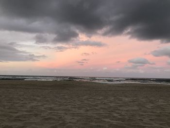 Scenic view of beach against sky during sunset