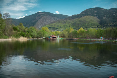 Scenic view of lake and mountains against sky