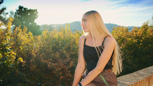 Woman standing against plants