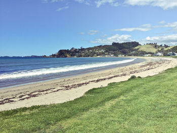 View of calm beach against blue sky